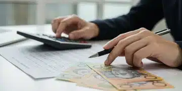 Hands calculating superannuation contributions with Australian dollars and statements.